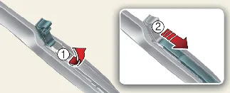 Releasing the locking clip on the Kia Carnival Type B wiper