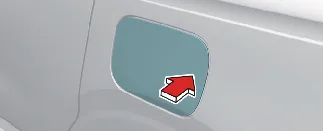 Pressing the edge of the Kia Carnival fuel filler door to release