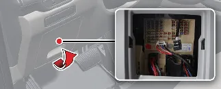 Accessing the interior fuse panel cover on the driver's side of the Kia Carnival