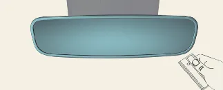 Positioning the handheld remote near the Kia Carnival rearview mirror